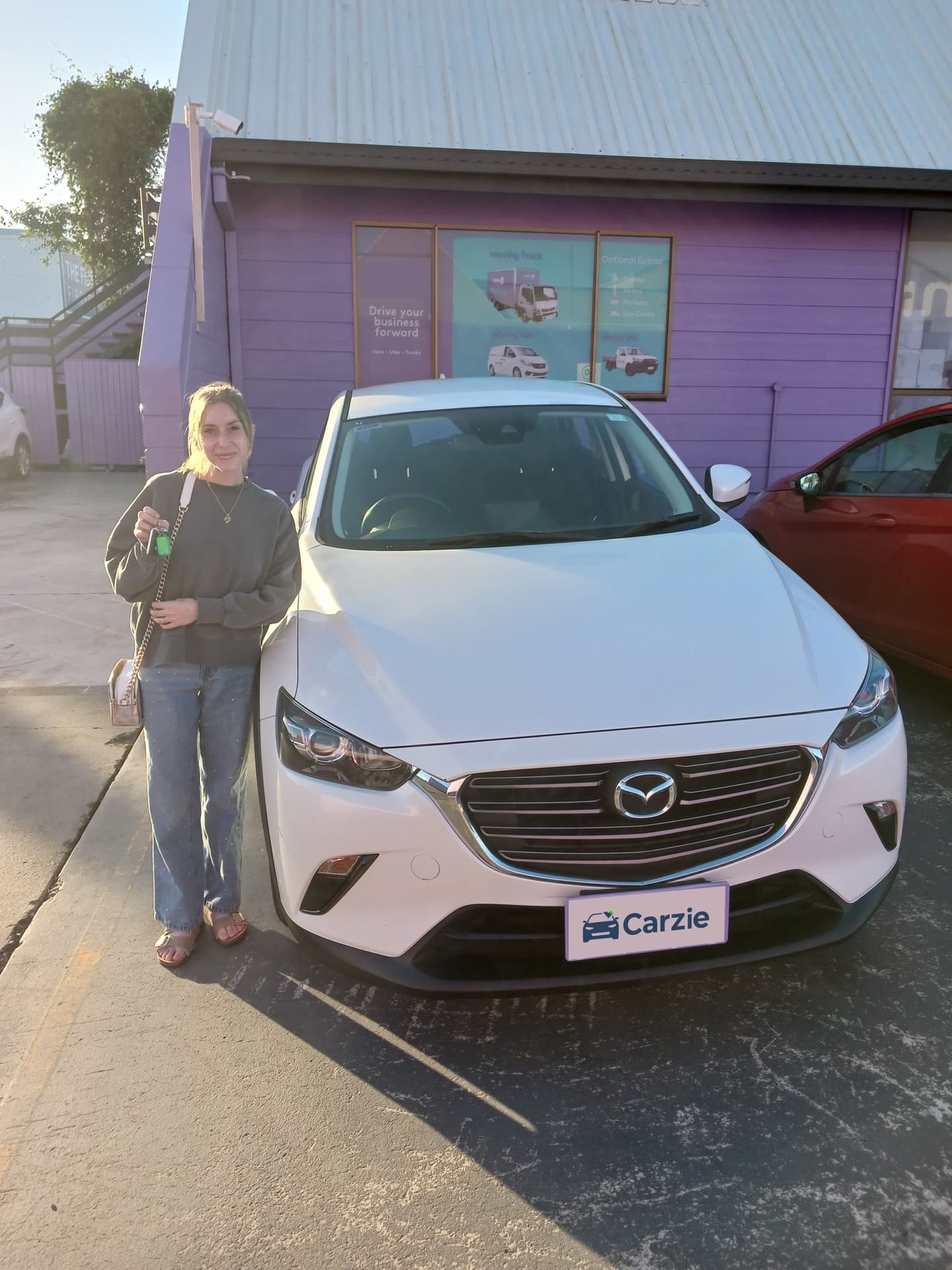 A Carzie customer with the white Mazda CX-3 Maxx Sport they lease